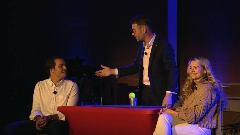 An interactive on-stage magic moment inviting audience participation at a corporate event.