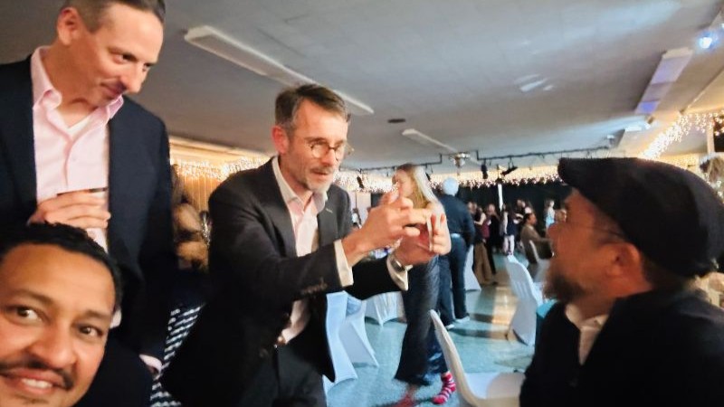 Close-up magic performed among guests during a corporate networking event.