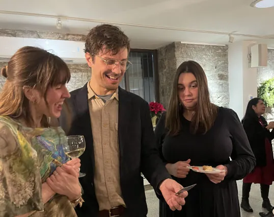 Small group reacting to a close-up card magic trick at an event