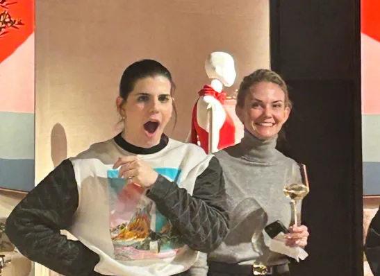 Two women reacting with amazement during a live close-up magic performance