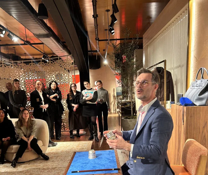 Magician performing a close-up magic show for a corporate audience