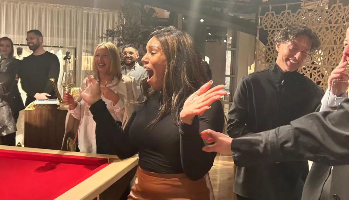 Guest reacting with amazement during a live magic performance at an upscale event