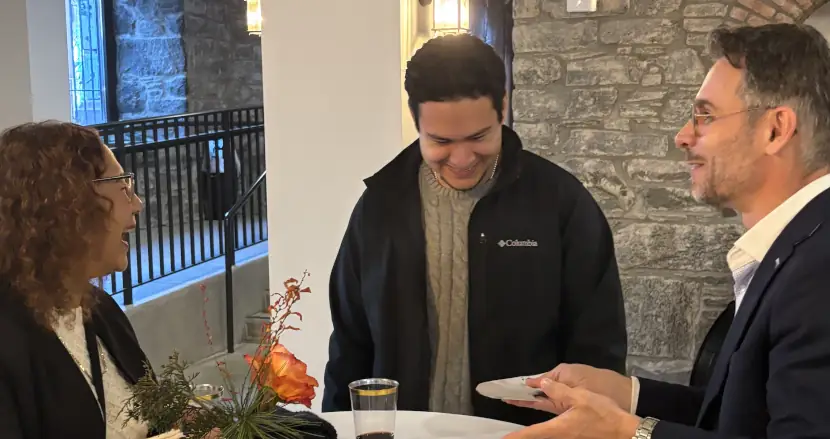 Magician performing a close-up card trick for a small group of guests