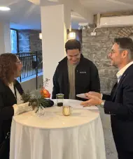 Magician performing a close-up card trick for a small group of guests