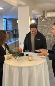 Magician performing a close-up card trick for a small group of guests