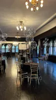 Elegant event room set with tables and chairs before guests arrive