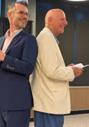 FX smiling back-to-back with a guest during an interactive magic performance
