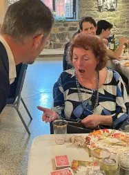 Surprised guest reacting to close-up magic performed at her table